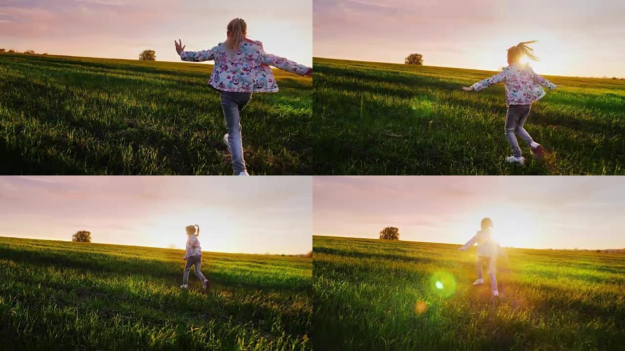 一个无忧无虑的女孩朝着日落的绿色田野奔跑。概念-快乐的童年，轻盈和自由。Steadicam射击