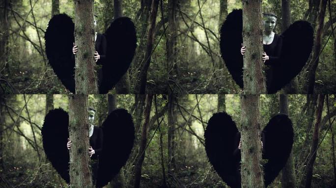 4k万圣节黑天使女人与黑色翅膀在森林隐藏
