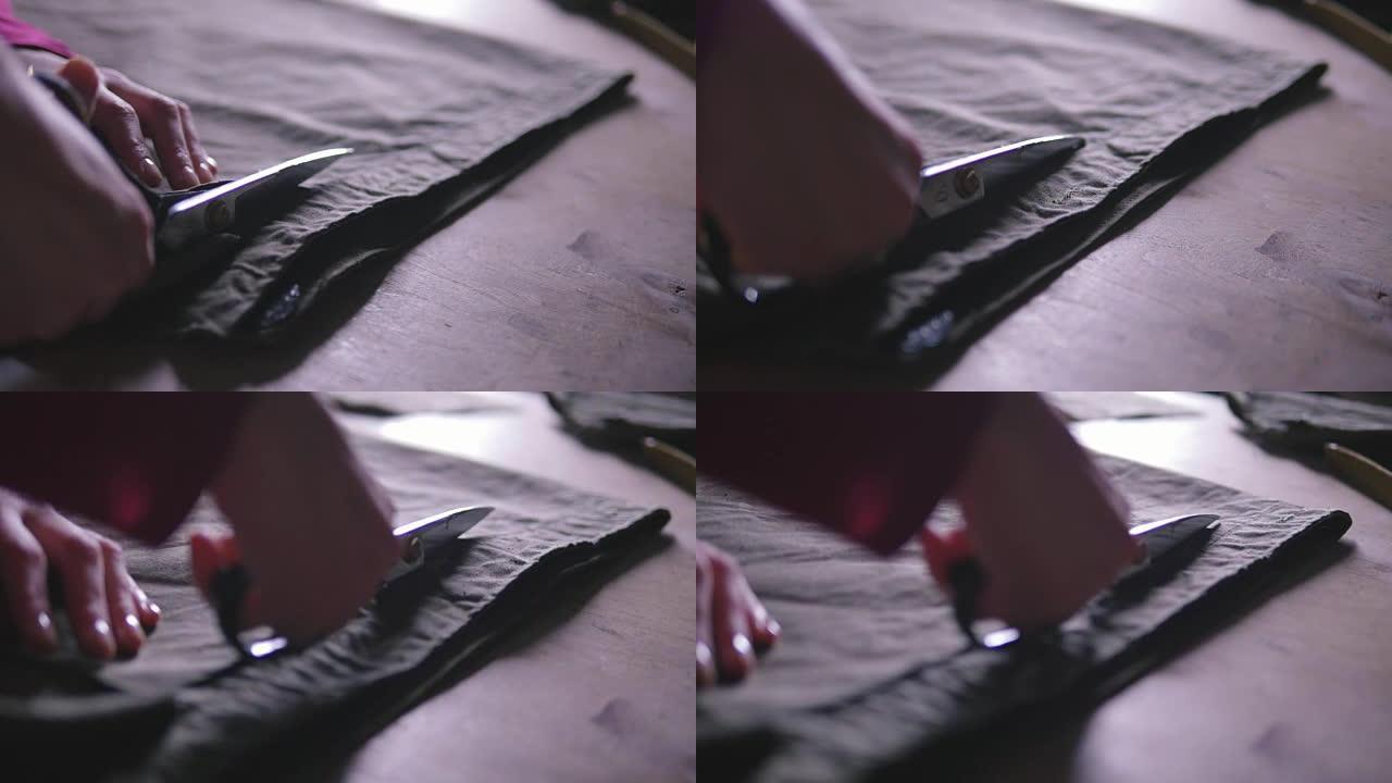 女人用剪刀手剪布的特写，慢动作