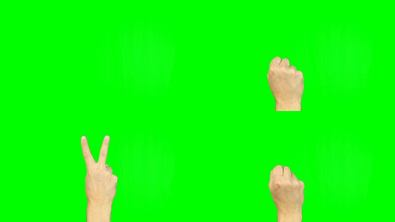 绿色屏幕上的胜利手势。胜利与和平情感的Simbol。镜头包含实心绿色，而不是阿尔法通道容易键控。男性