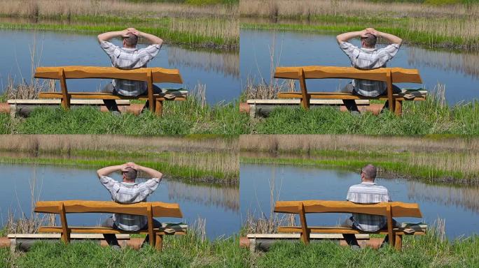 男子在河附近的长凳上放松
