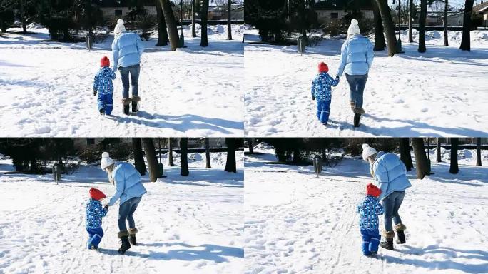 冬天，母子在阳光下在公园散步。