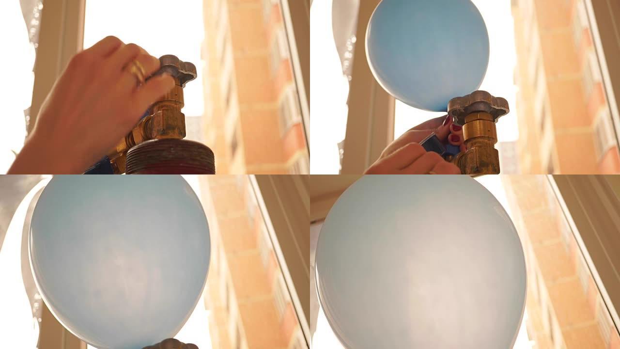 女孩用氦气给蓝色气球充气。特写镜头