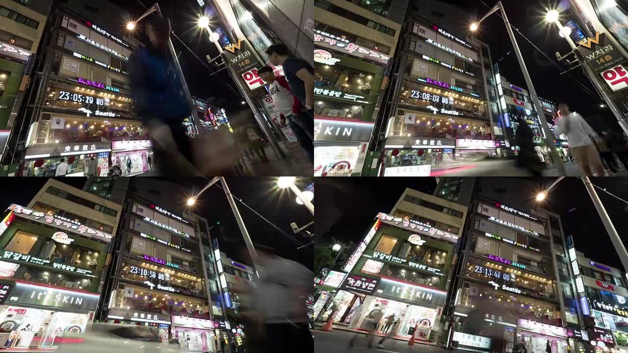 夜间街道的时光倒流，建筑物上有发光的横幅。韩国首尔