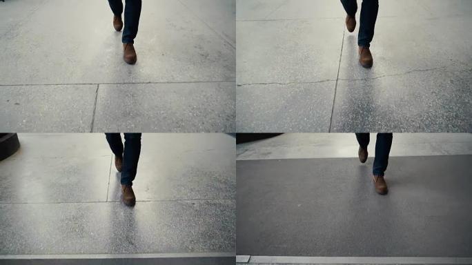 在混凝土上行走: 男人皮鞋的特写镜头