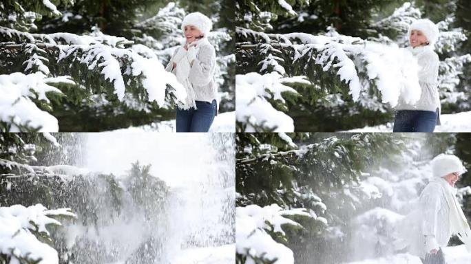 有吸引力的女性击败了枞树的树枝，并摆脱了积雪