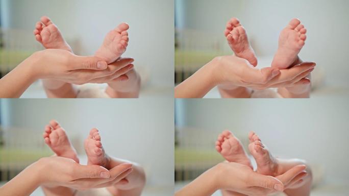 母亲的手抚摸着新生儿的婴儿的脚