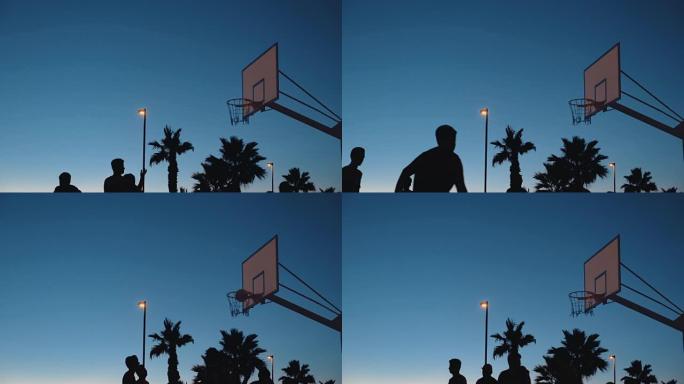 青少年打街头篮球的剪影
