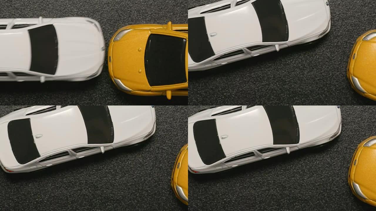 俯视图: 车祸-玩具模型车撞到白色玩具车的特写镜头 (慢动作)