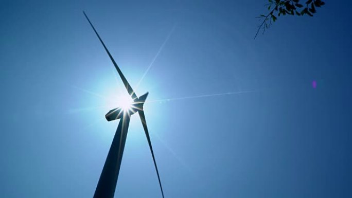 阳光明媚的蓝天中的风力涡轮机为地球提供新时代的能源