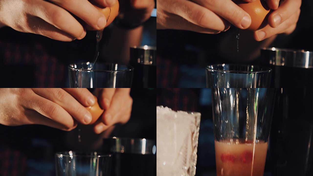 调酒师用手制动鸡蛋并将其放入玻璃杯中制作鸡尾酒