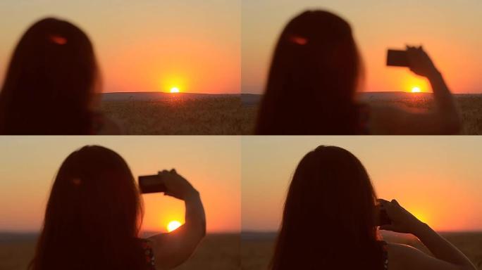 女孩带着手机在日落的夜晚风景图片日落在手机上美丽。