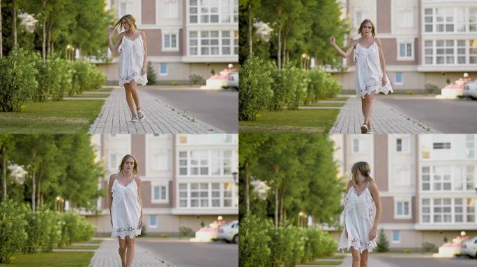 一个穿着白色名牌连衣裙的女人在夏日慢慢走在街上，一个金发女郎正踩在人行道上