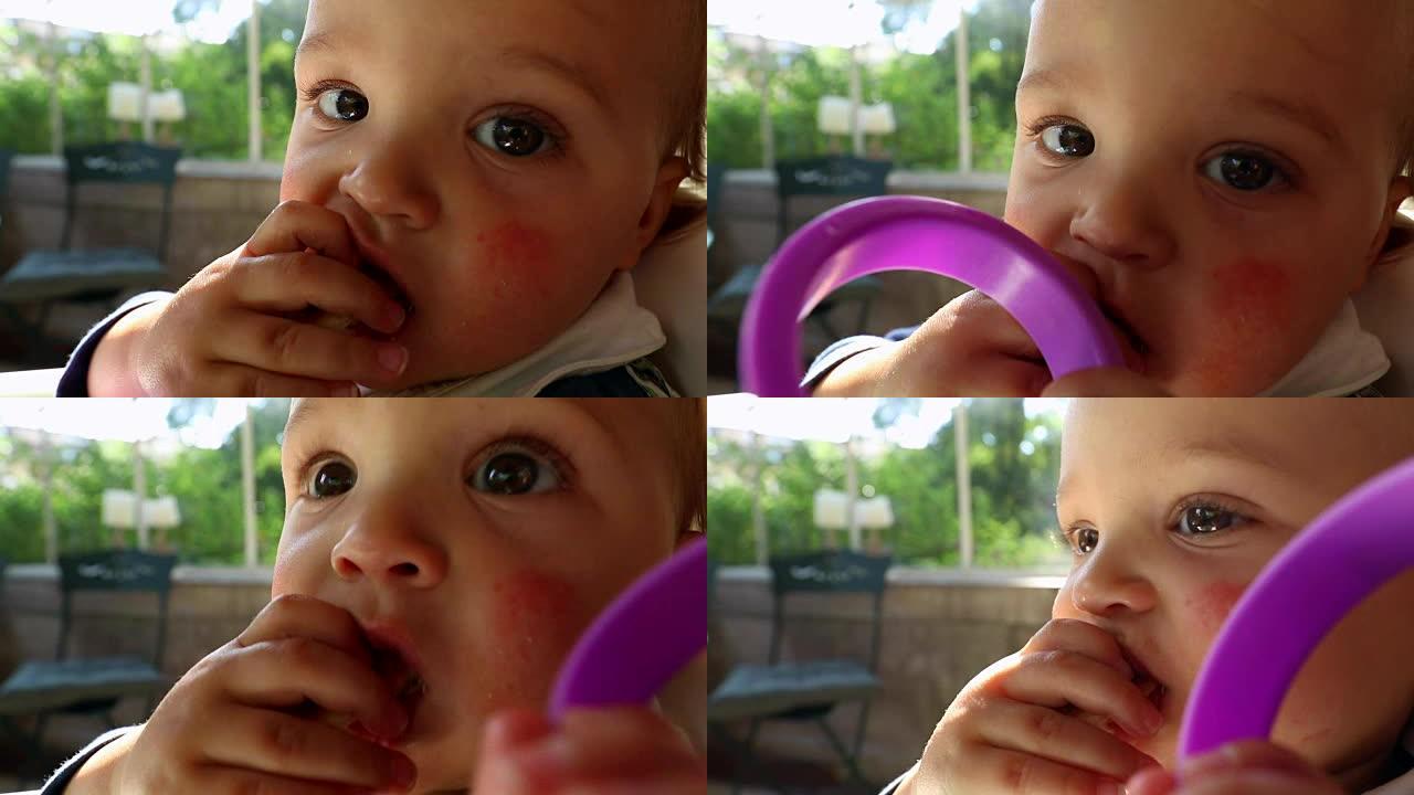 可爱的宝宝吃蛋糕。可爱的婴儿的肖像直接对着相机