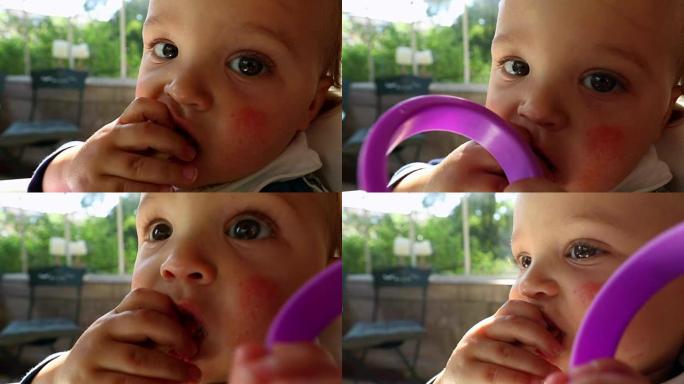 可爱的宝宝吃蛋糕。可爱的婴儿的肖像直接对着相机