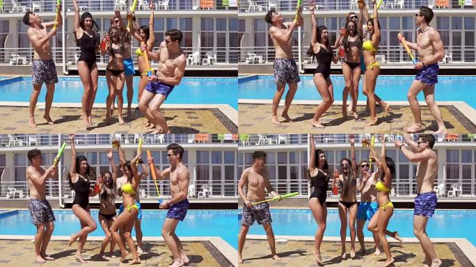 快乐的年轻快乐的朋友在游泳池跳舞和娱乐。夏季泳池派对。慢动作镜头