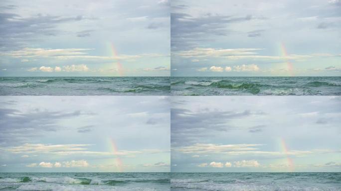海上的小彩虹在日落和雨后的大海