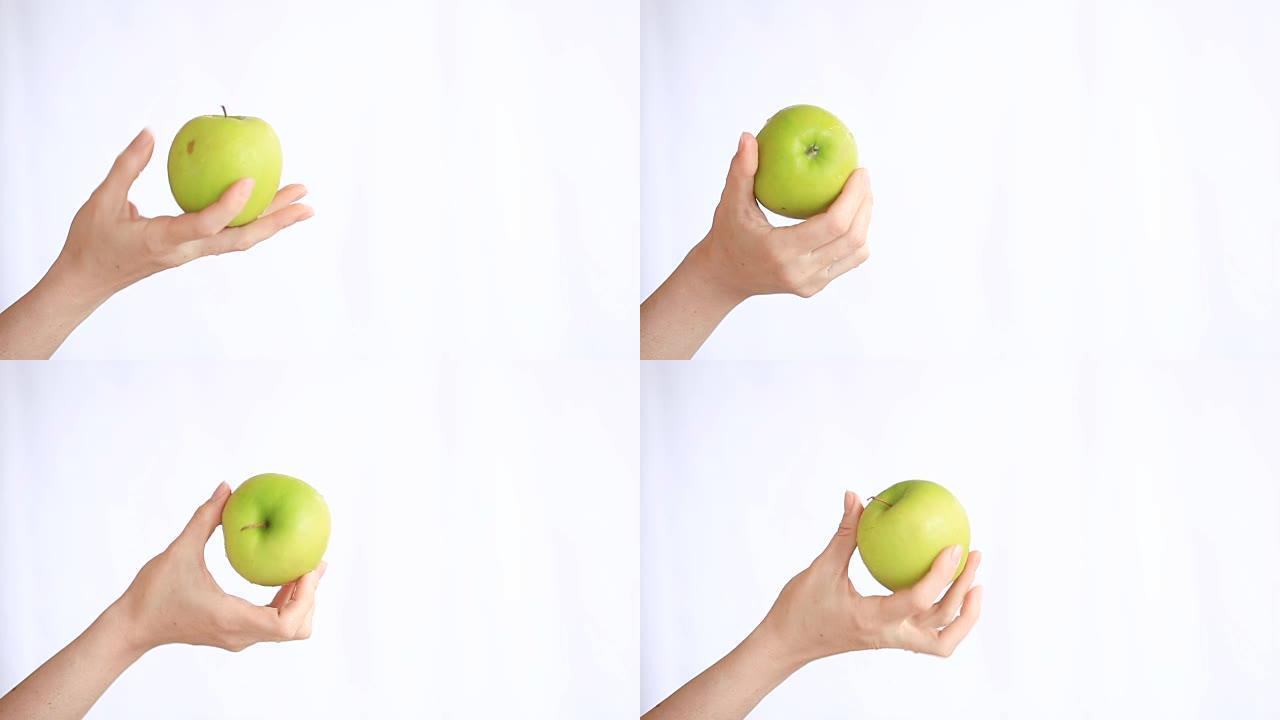 女手握著白底青苹果