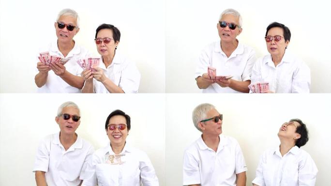 快乐富有的亚洲老年夫妇视频。中了彩票或赌场现金