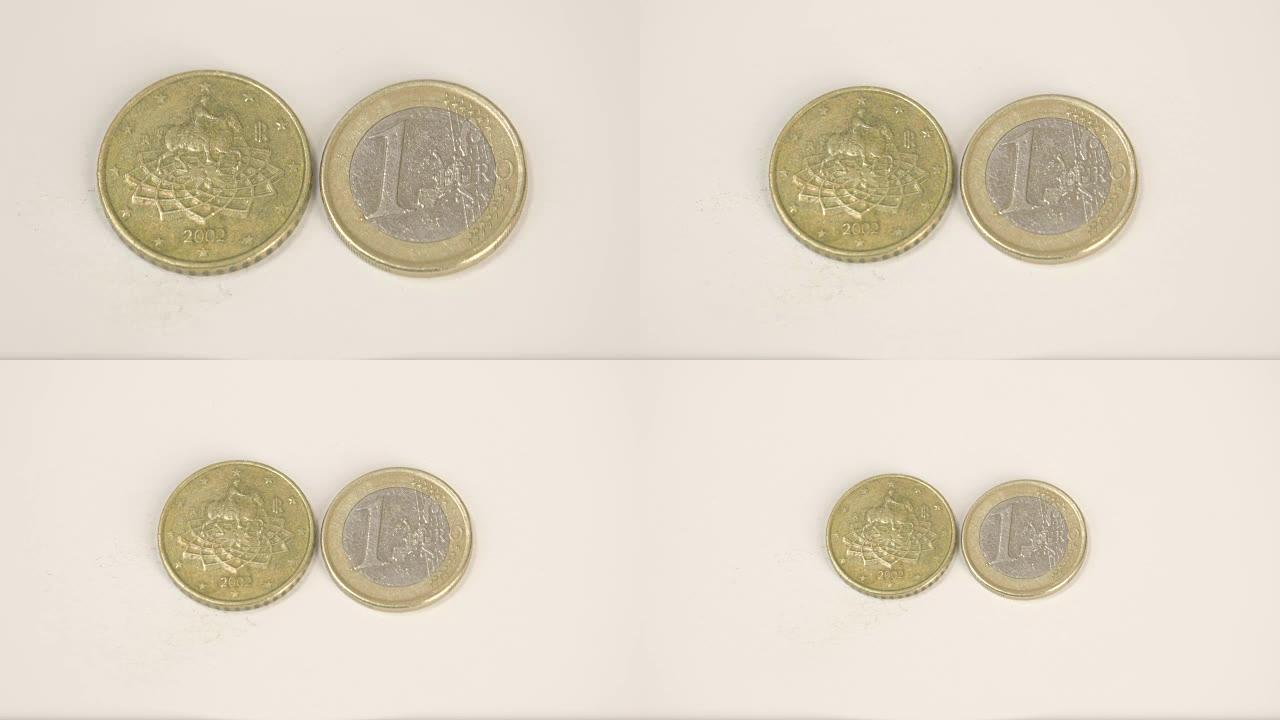 桌上的欧元意大利硬币一枚金币和一枚1欧元硬币