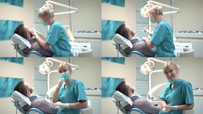 女牙医钻牙齿，看着镜头。