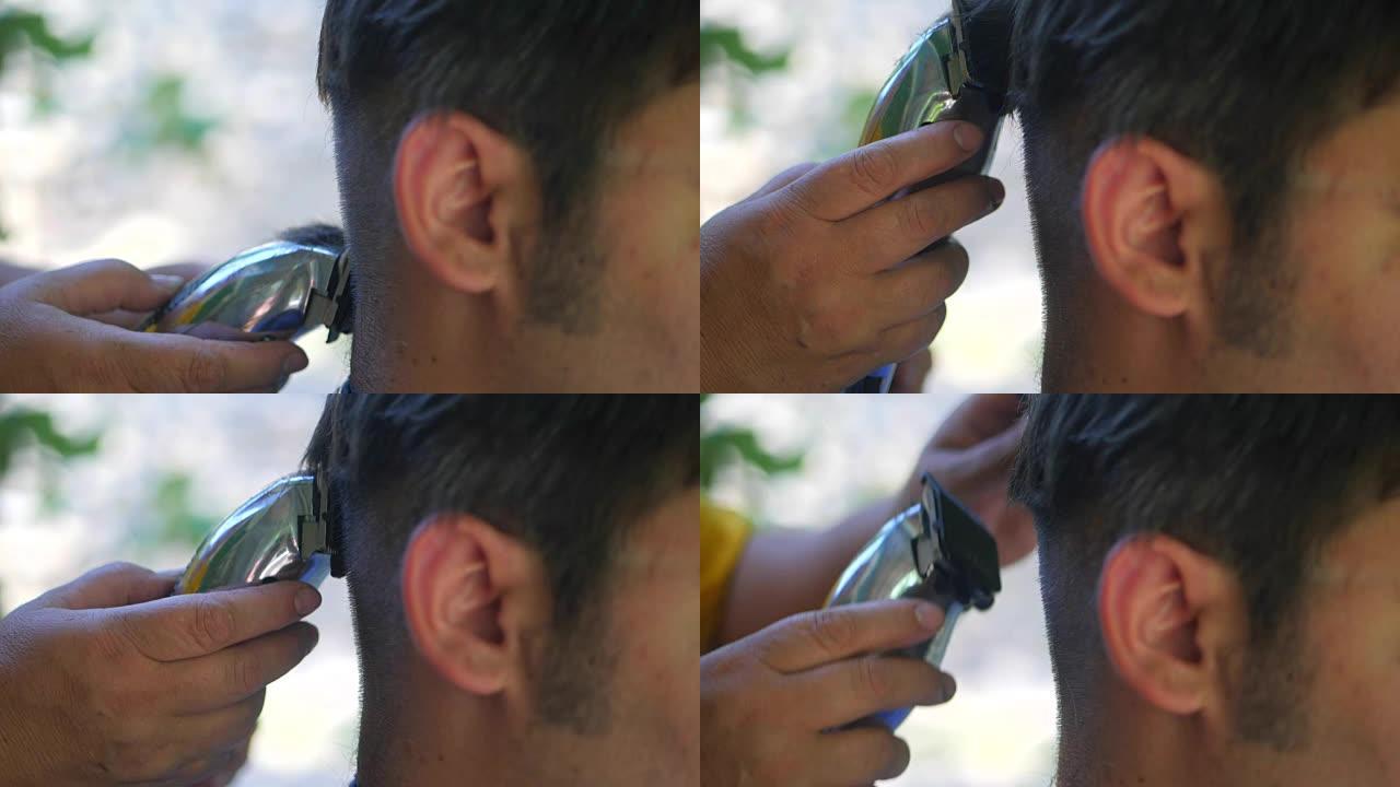男人被理发师理发。一名中年妇女理发师使用机器切割一个黑发男人。夏天在户外理发。特写，慢动作