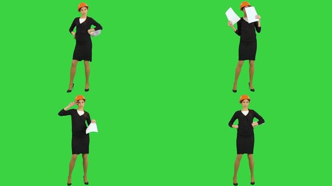 女工程师戴着头盔，拿着文件，在绿屏上跳着有趣的舞蹈
