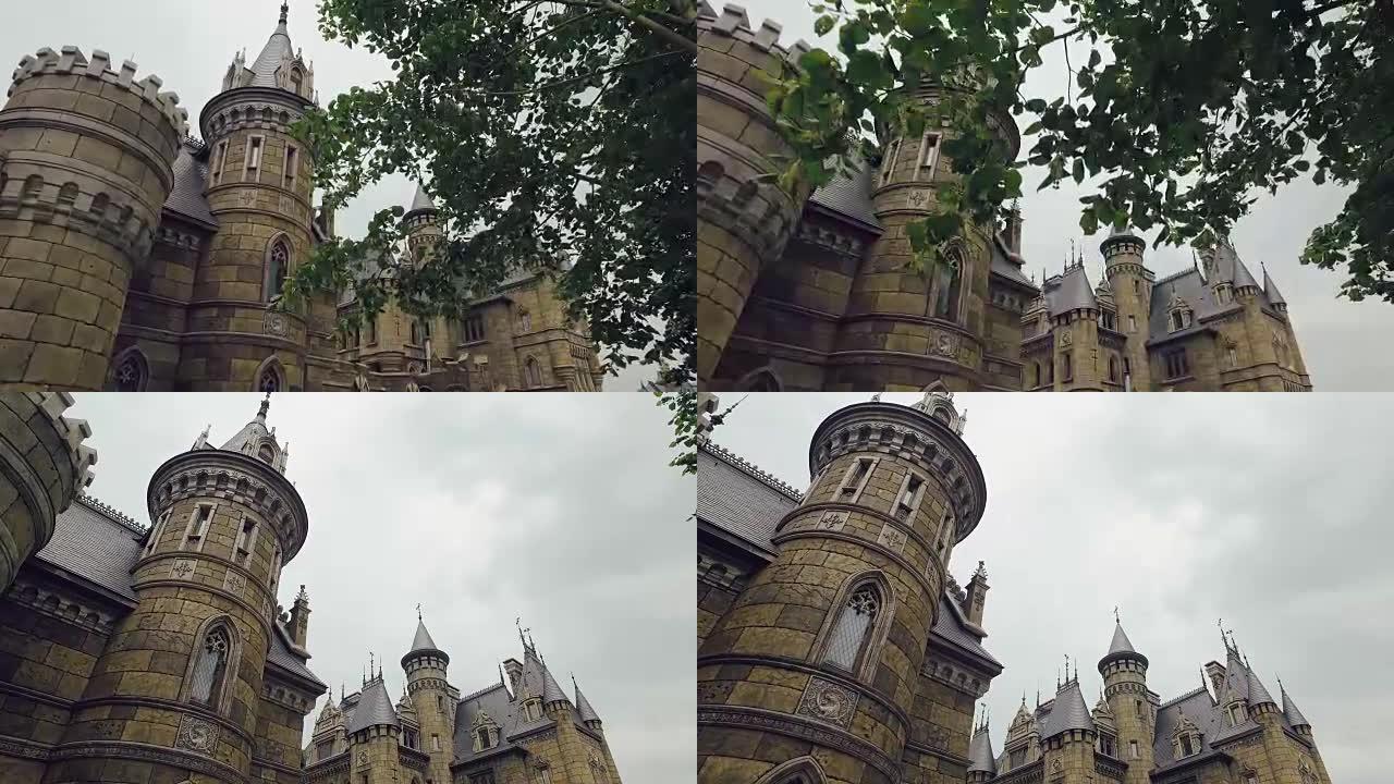 夏日里令人惊叹的中世纪堡垒，相机穿过树枝向前移动