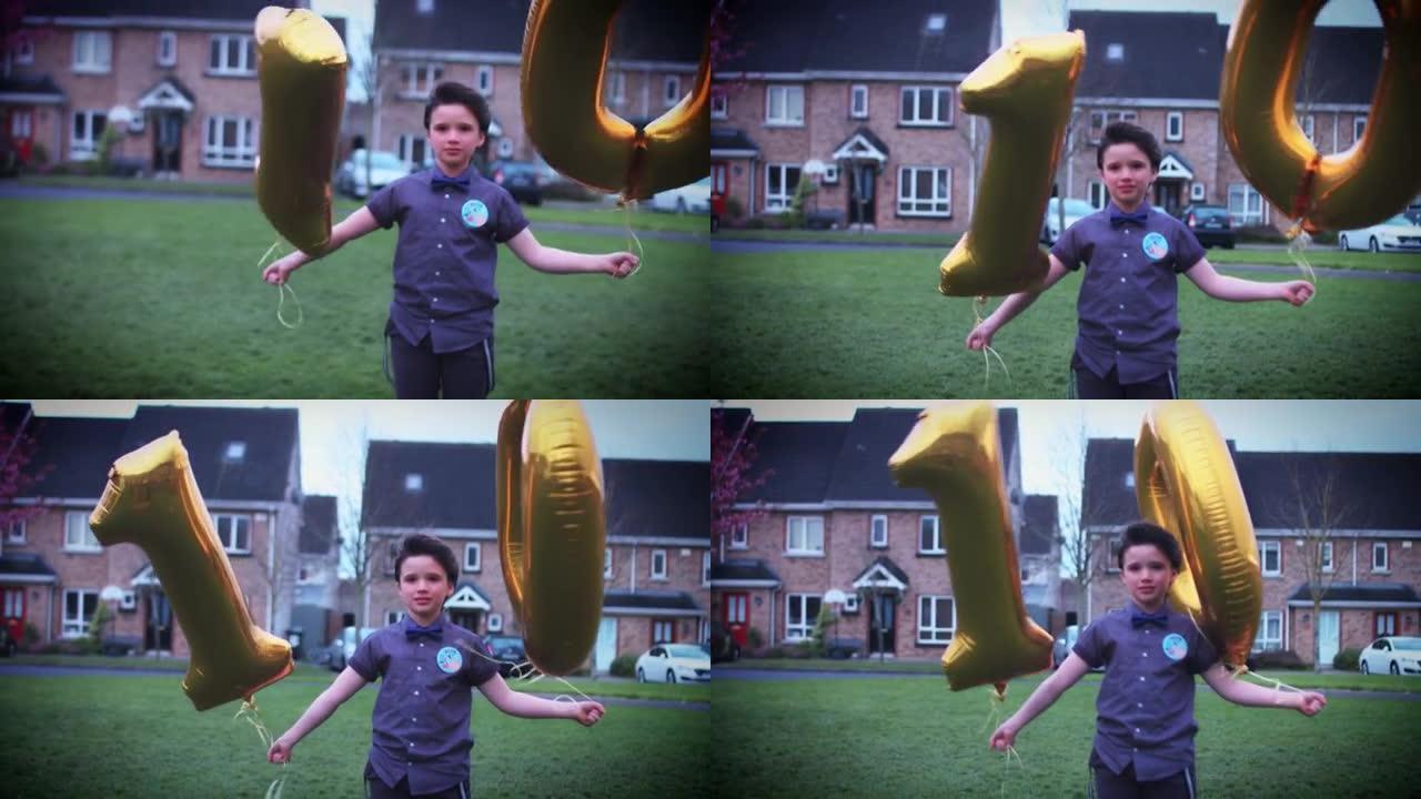 4k派对10岁生日男孩与气球在户外摆姿势