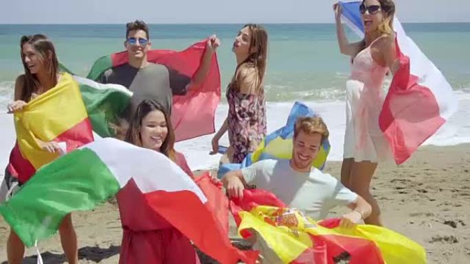 一群朋友在沙滩上踢足球和旗帜
