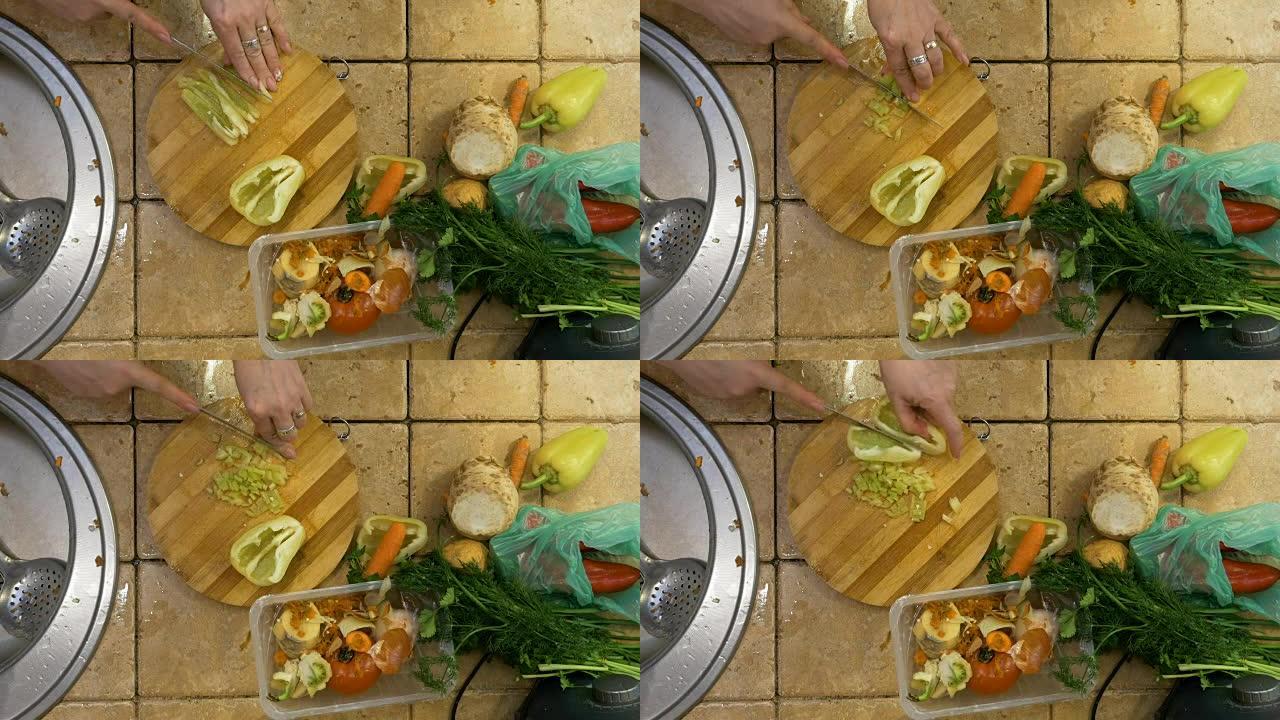 有爱心的成年家庭主妇在厨房切蔬菜的俯视图，为午餐准备美味的素食汤