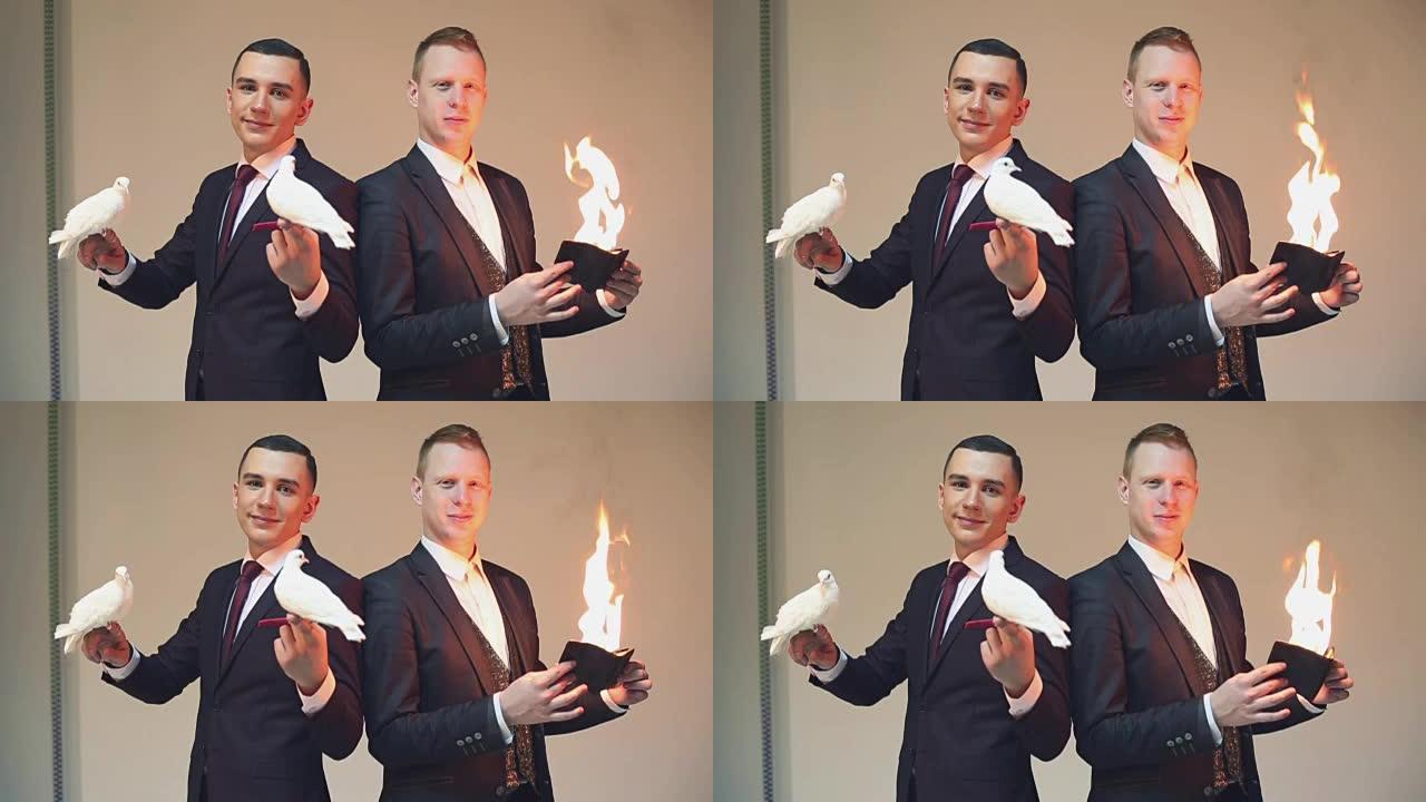 舞台上的魔术师带着白鸽和燃烧的火。