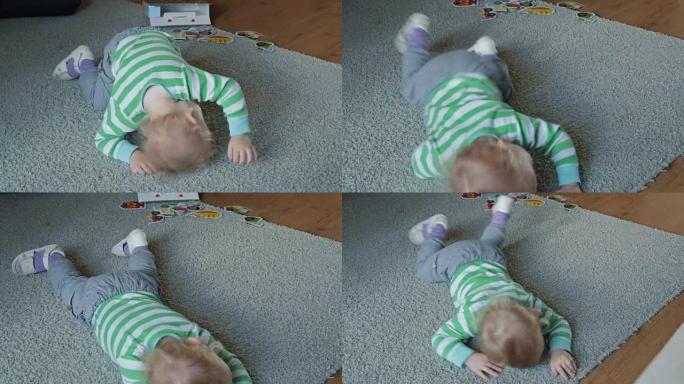 男孩在轻便的地毯上爬行