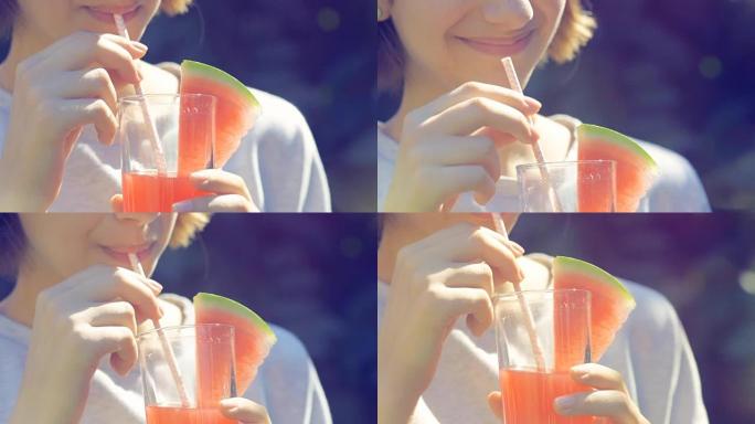 年轻女子喝新鲜的西瓜汁。