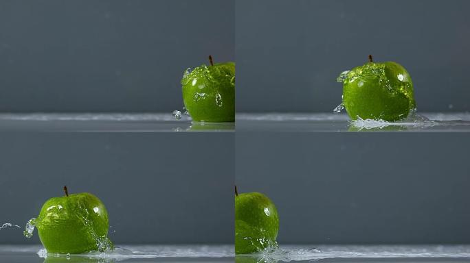 奶奶史密斯苹果，苹果苹果，黑色背景下落在水上的水果，慢动作4K