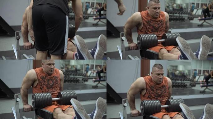肌肉发达的健美运动员在健身房锻炼。在健身房举重的人。