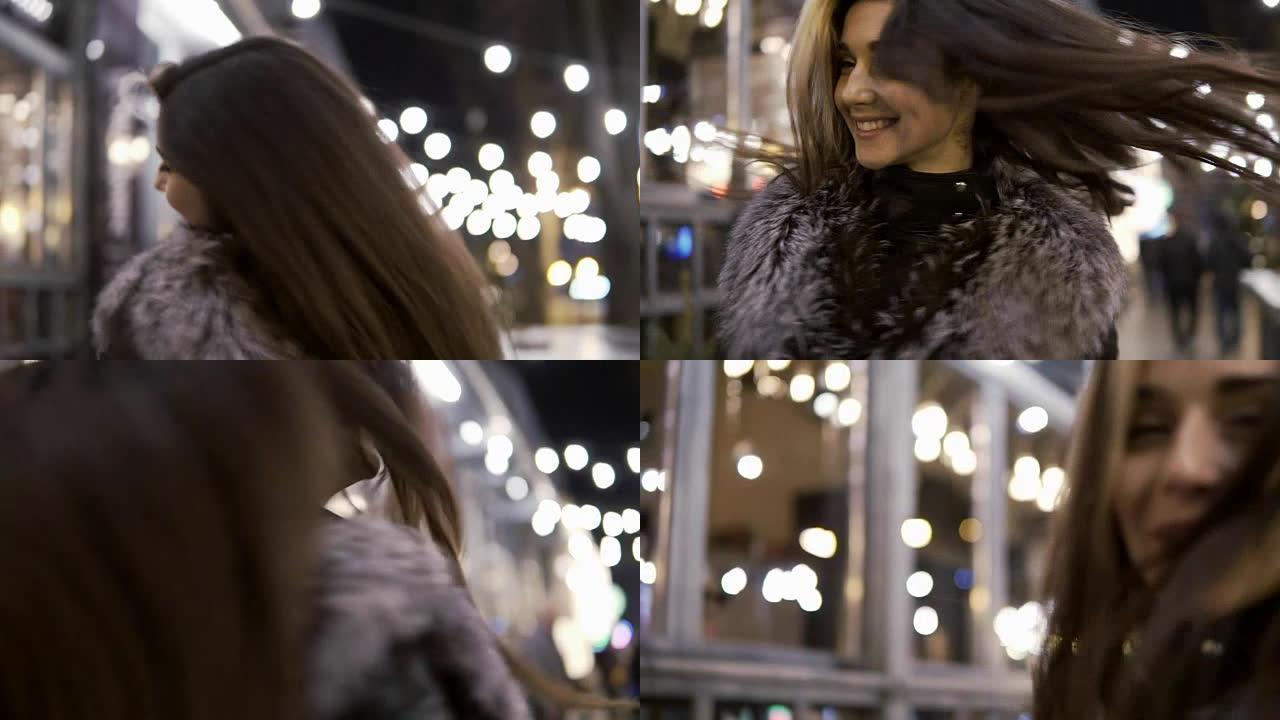 年轻漂亮的女人在夜晚的灯光下在城市街道上微笑