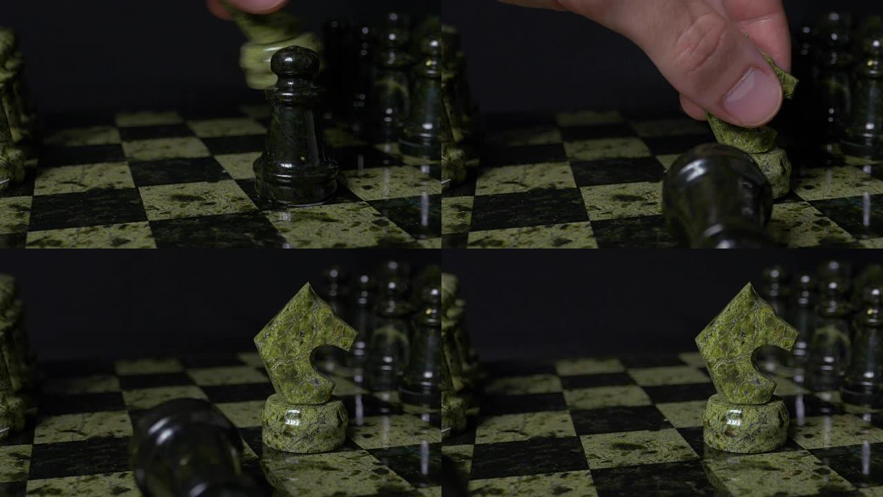 盖斯白马击败黑兵。选择性聚焦。象棋、马和棋子。黑色背景上的棋子细节