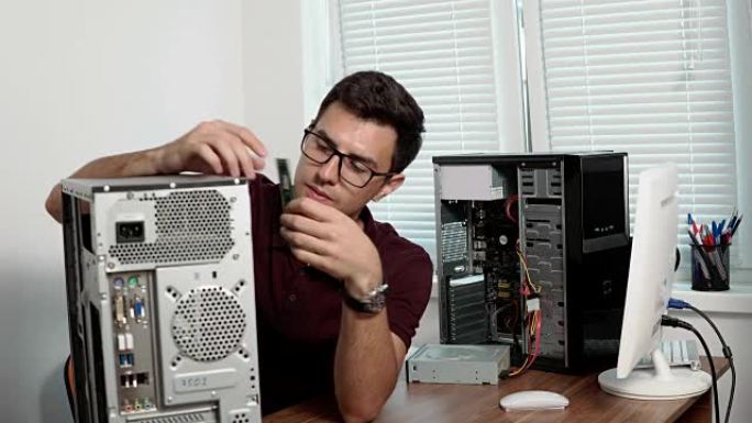 眼镜的集中计算机服务人员在办公室修理坏掉的计算机并升级计算机硬件。支持团队。计算机维护。4k拍摄