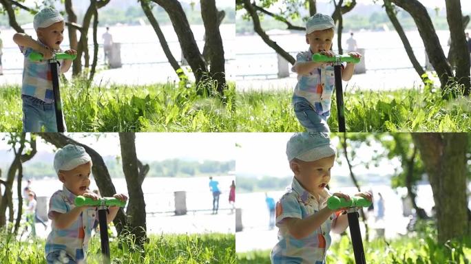 可爱的小男孩戴着帽子骑迷你踏板车，在阳光明媚的夏日慢动作在公园踢踏板车。1920x1080