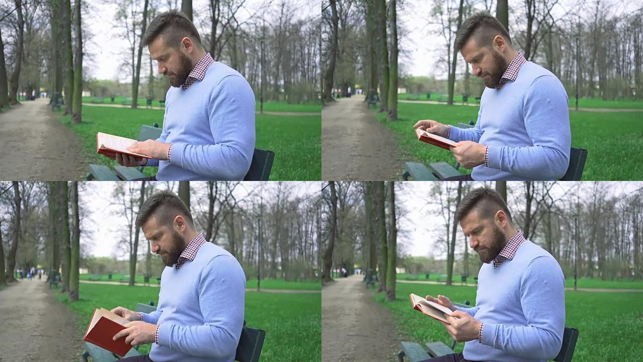 男子坐在公园读书的长凳上，steadycam射击