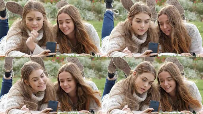 两名年轻女子在手机摄像技术上搞笑表情面孔