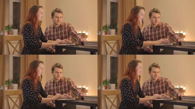 年轻夫妇在网上讨论购买笔记本电脑