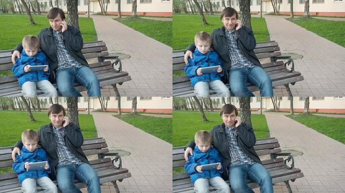 父亲和他可爱的小儿子在公园里