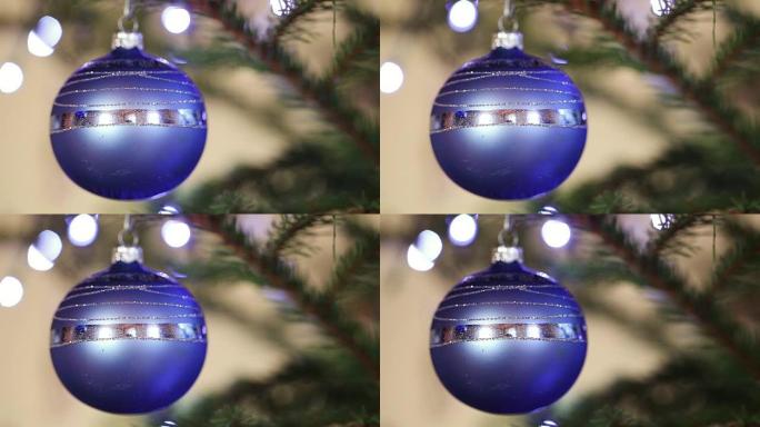 云杉树枝上的圣诞球背景闪光灯。