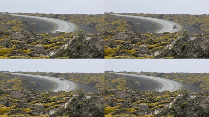 横跨旧熔岩场的现代柏油路，汽车在行驶，冰岛景观