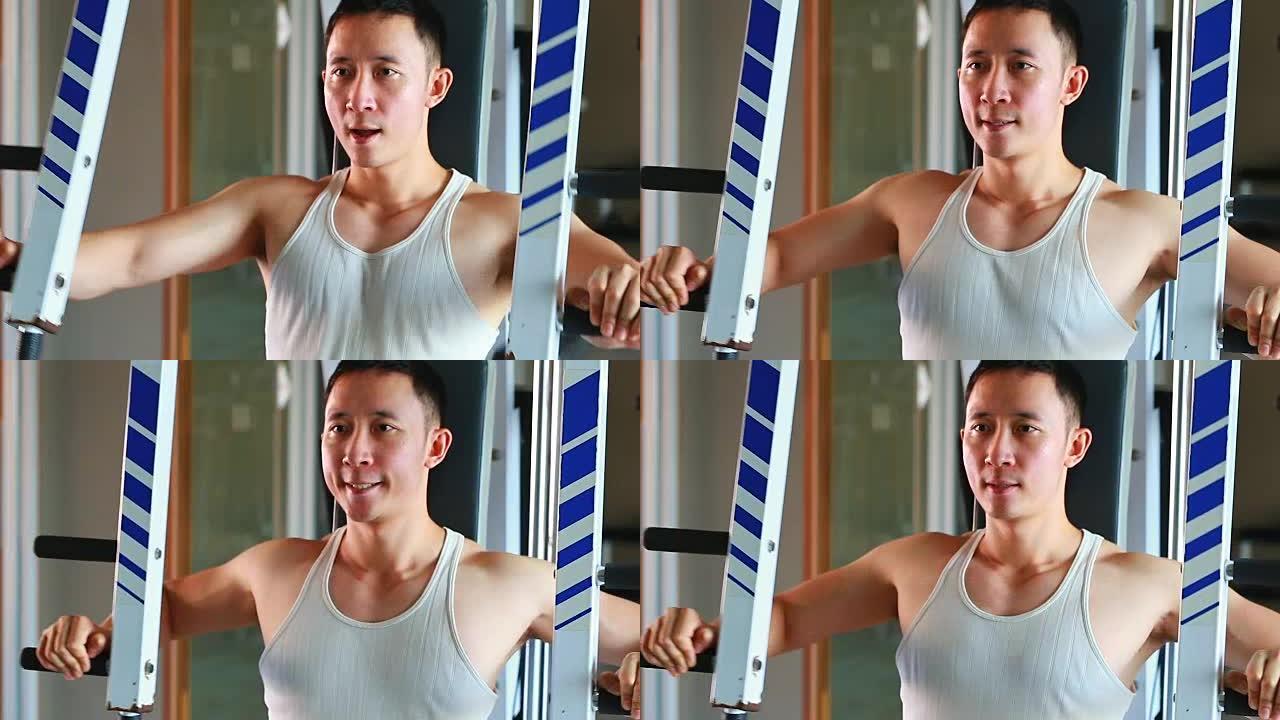 亚洲年轻人在健身房锻炼的特写镜头