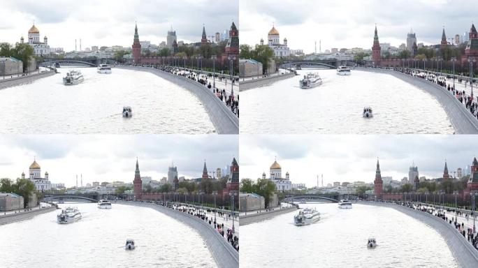 胜利日不朽军团游行的结束 -- 人们沿着莫斯科河堤沿着克里姆林宫的城墙行进; 以救世主基督圣殿、河流