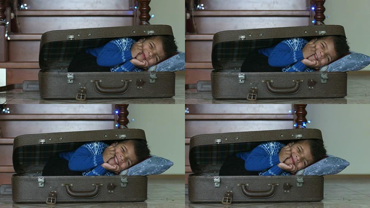 睡在手提箱里的男孩。