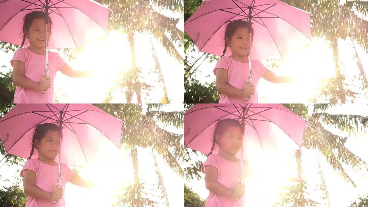 慢动作可爱的亚洲小女孩撑伞玩得开心雨和阳光